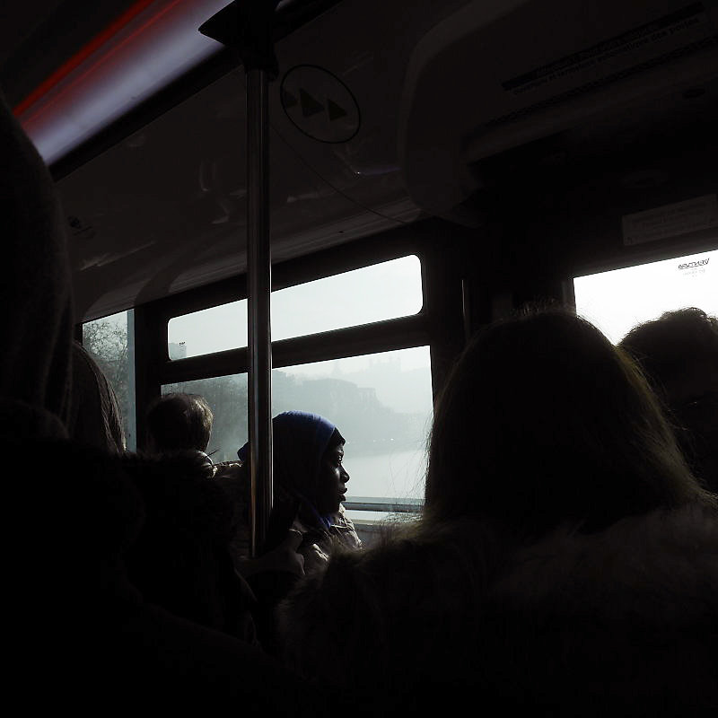 femme noire regardant par la fenêtre dans un bus en hiver